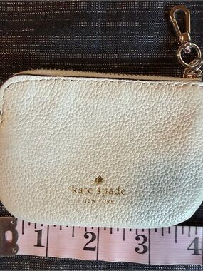 Kate Spade cream pebbled leather zip pouch with gold details